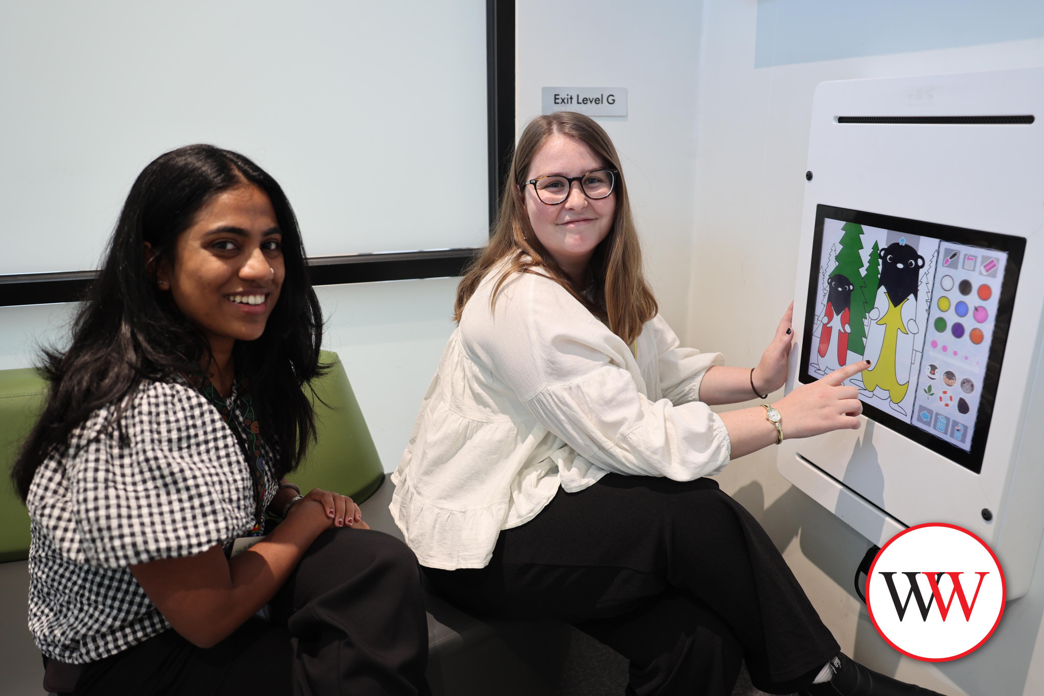 Mental health clinicians Sangeetha Varghese and Molly McMeel have some fun with the new interactive panel recently installed in the emergency department at Warrnambool hospital.