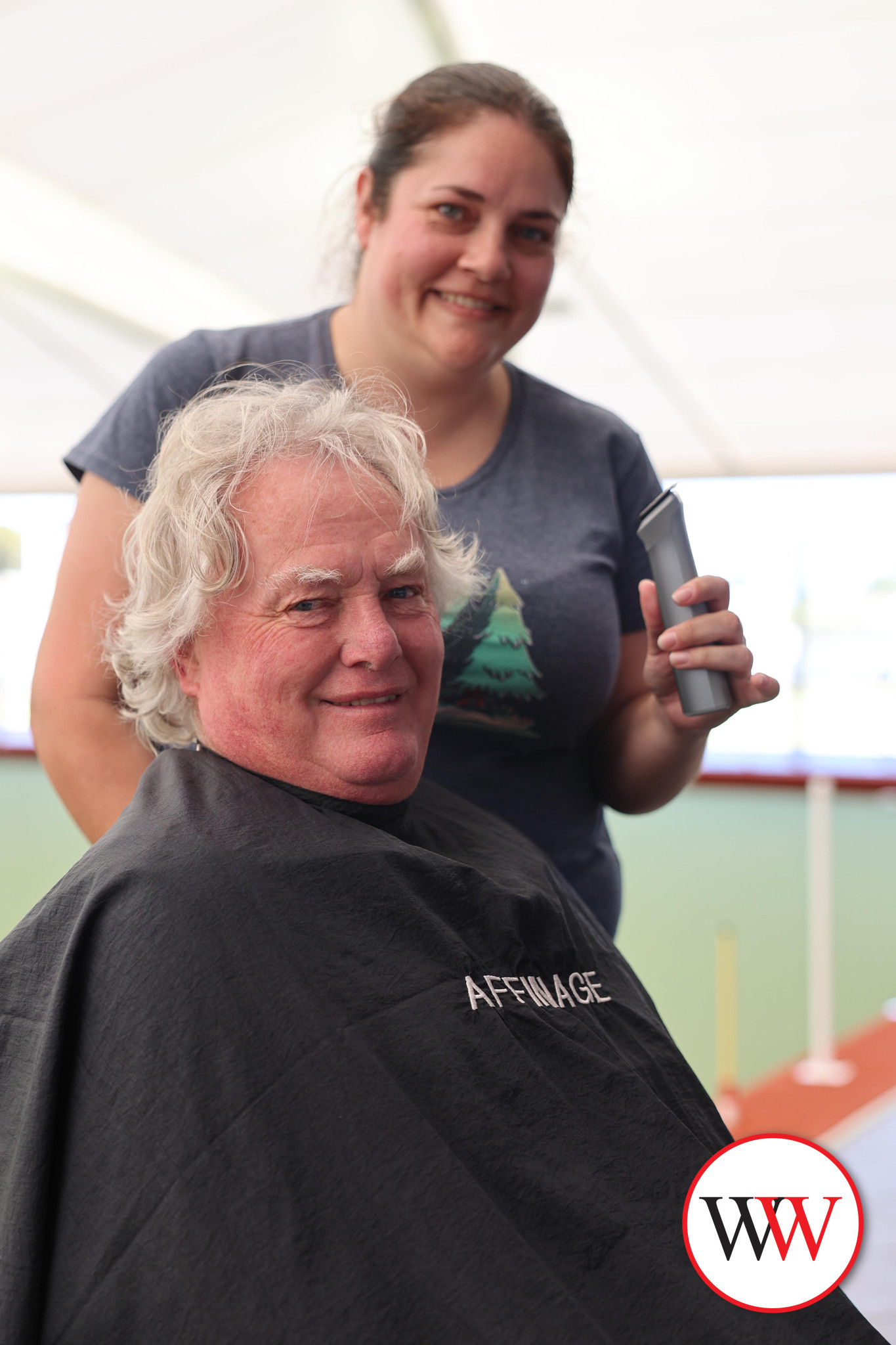 Don Price prepares to have his head shaved by Warrnambool’s Ebony Baker.