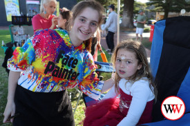 Mak McRostie paints the face of four year-old Vali Coffey of Warrnambool.