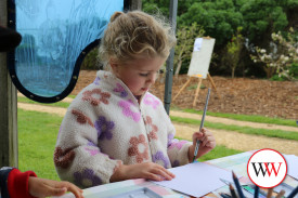 Zephyr Smith has fun with a paintbrush.