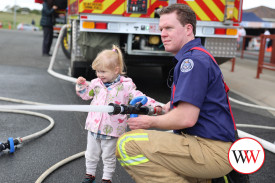 Warrnambool’s Addison McKay-White (2) kept a close eye on the target while helping Warrnambool Fire Brigade volunteer Aaron Hume with the hose.