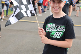 Nine year-old Jack Walker of Warrnambool was happy to walk around the showgrounds waving his chequered flag.