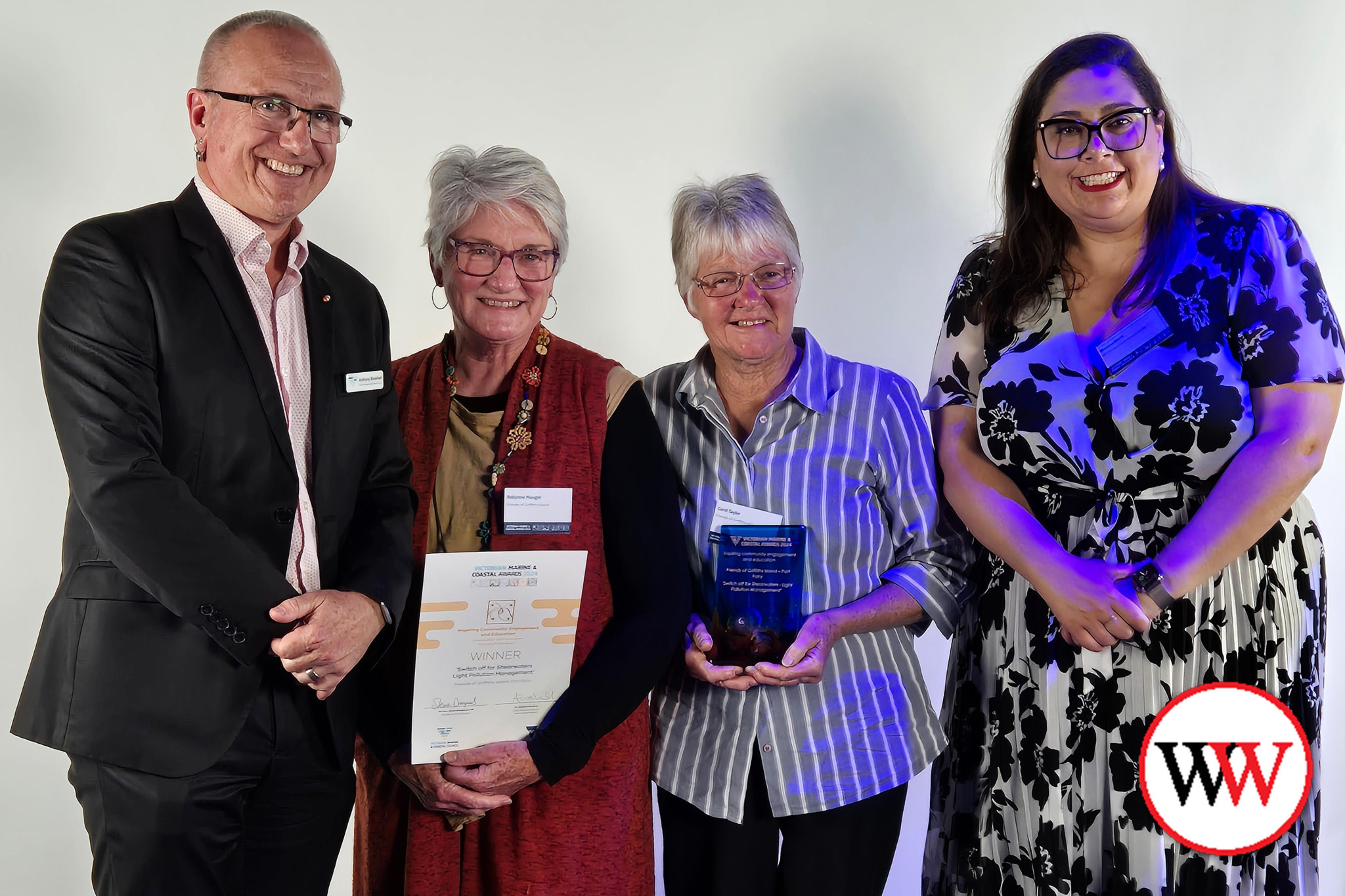 Members accept the ‘Inspiring Community Engagement and Education’ award at Docklands.