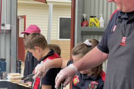 Phil Ryan with Lily, Jobling, Alby, Jobling, Elva and Ryan manning the barbecue.