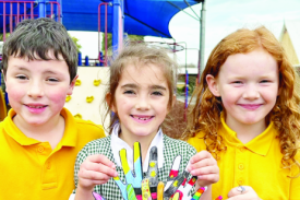 Year one students Harvey, Amelia and Scarlett show their collaborative classroom art piece.