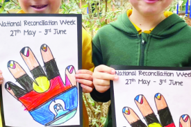 Foundation students Billy and Varni with their artwork using the colours of the Aboriginal and Torres Strait Islander flags.