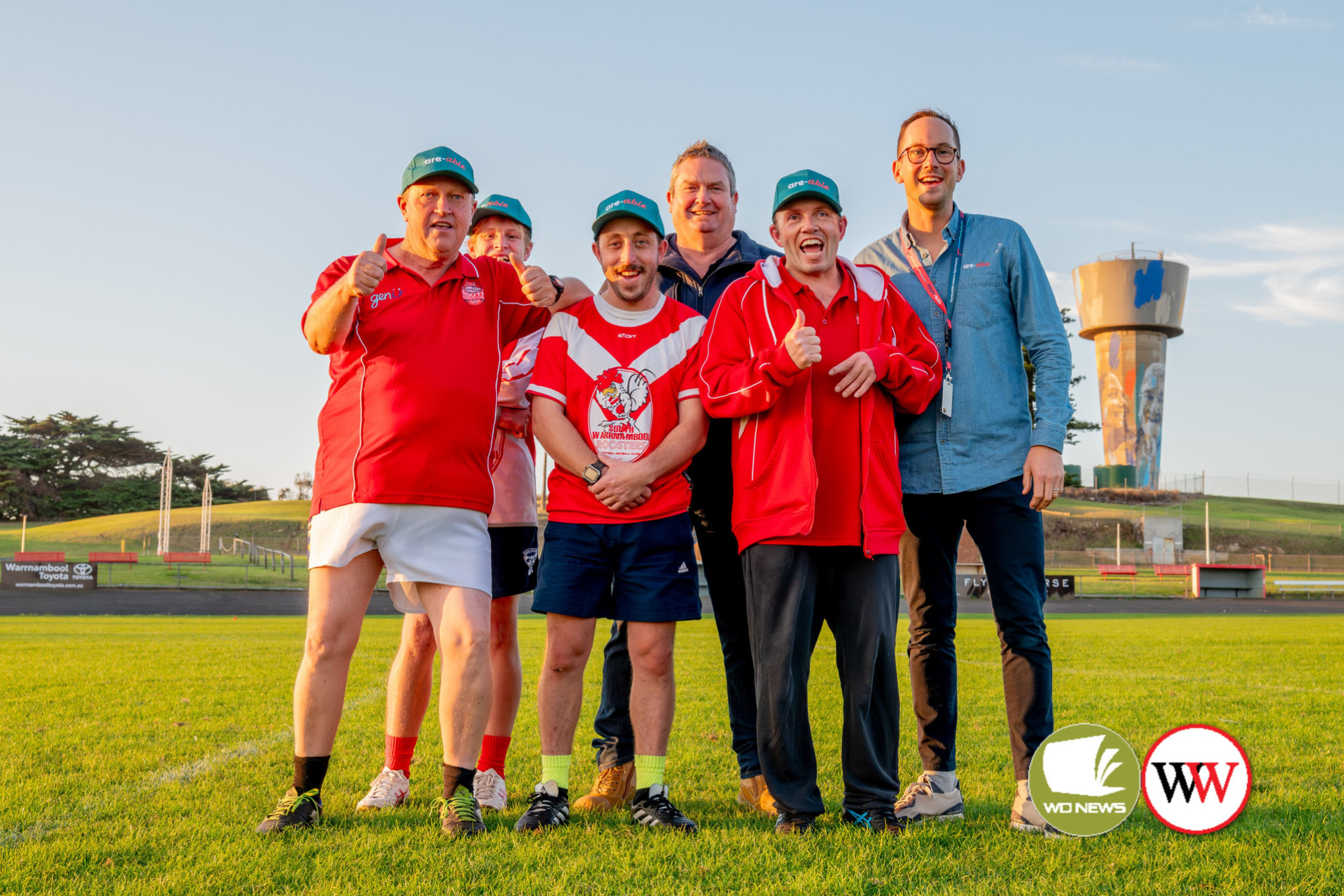 General manager of are-able Social Enterprise Paul Hughes (centre) and marketing and engagement specialist with are-able Nigel Jamison (right) celebrate the union with South Warrnambool Roosters All-Abilities team with team-members Tim Baulch, Kobe Quarrell, Peter Byrne and Tom Leembruggen.