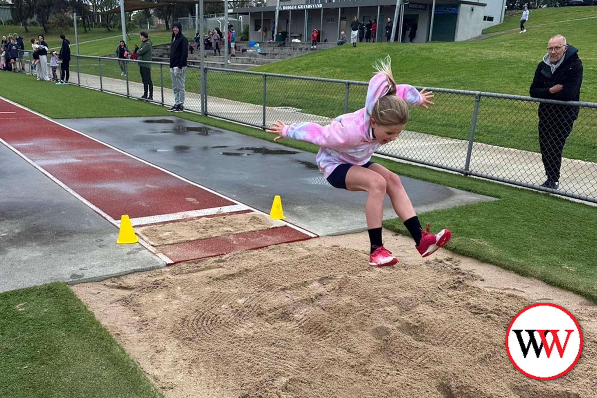 Charlee Best gives her all at the long jump pit.