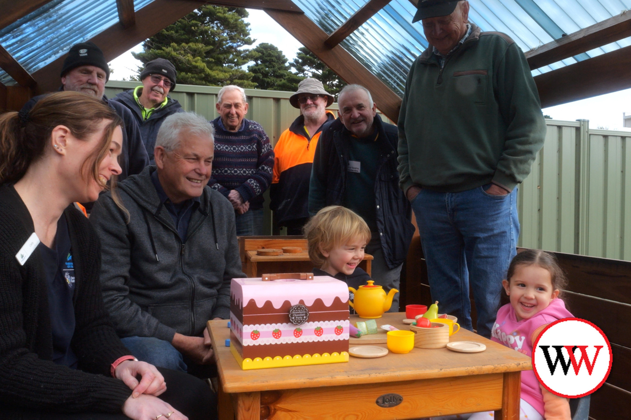Remi McSween and Elana Young were thrilled to be able to play in the new cubby house, watched by members of the Warrnambool Men’s Shed.