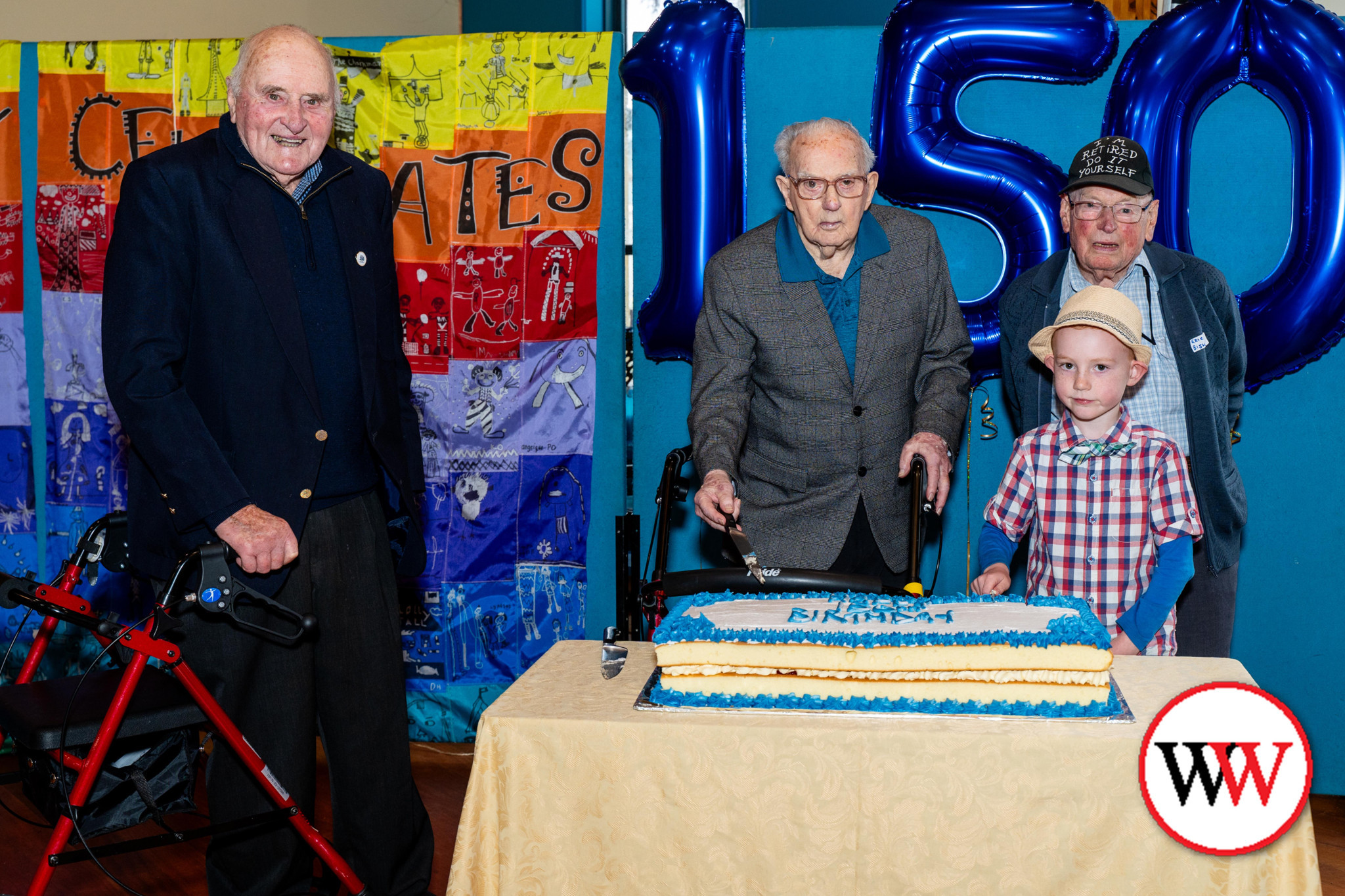 Port Fairy Consolidated School’s youngest student, Austin Sealey, cut the birthday cake along with Eric Bishop, Frank Pevitt and Des Chapman. Picture courtesy Jason Dargan