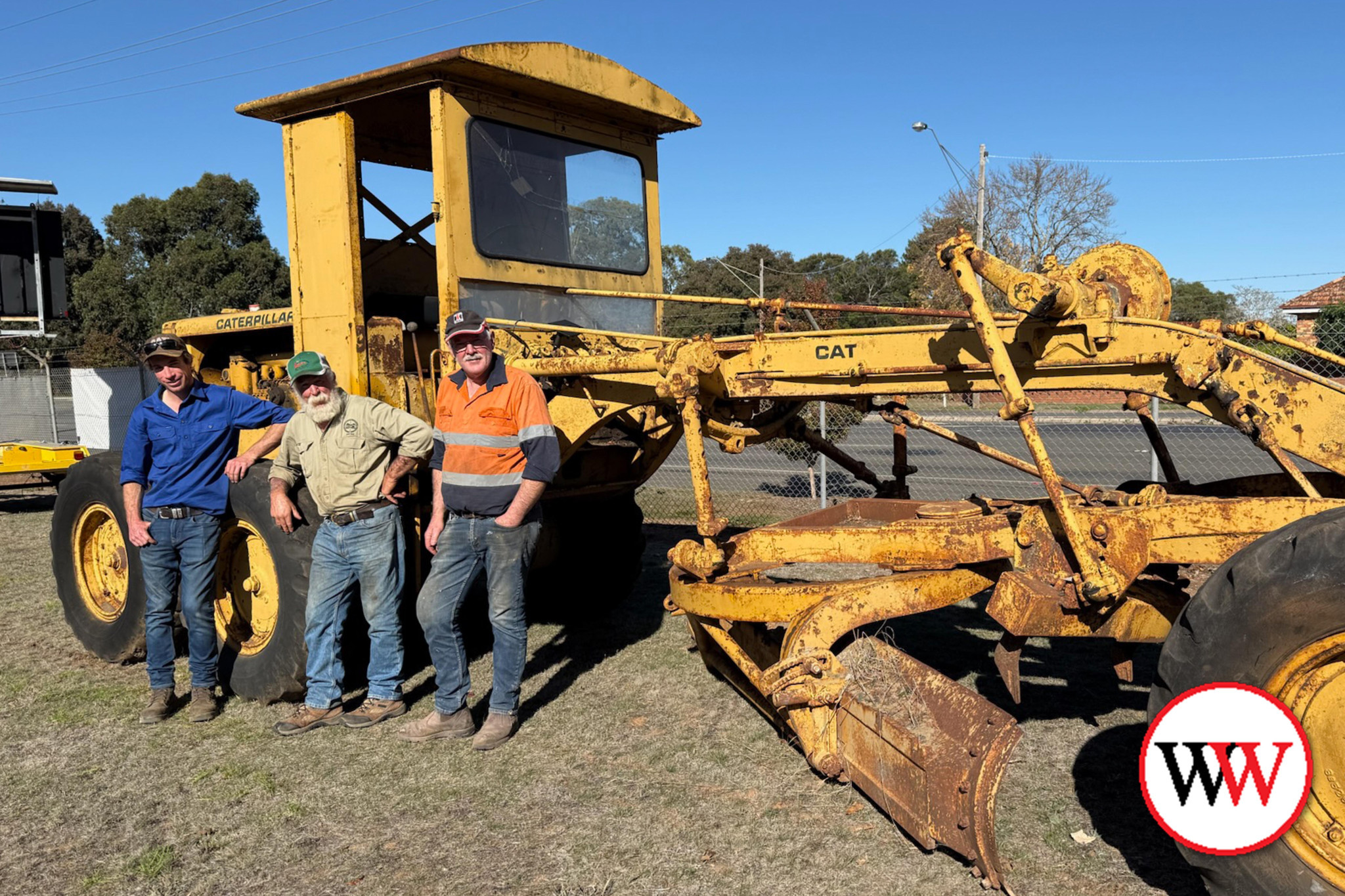 This 1950 Caterpillar grader, owned by Matthew McArthur, will be among those on display this weekend. Pictured with the machine is, from left, Matt Jenkins, Graeme Jenkins and Glenn Sobey.