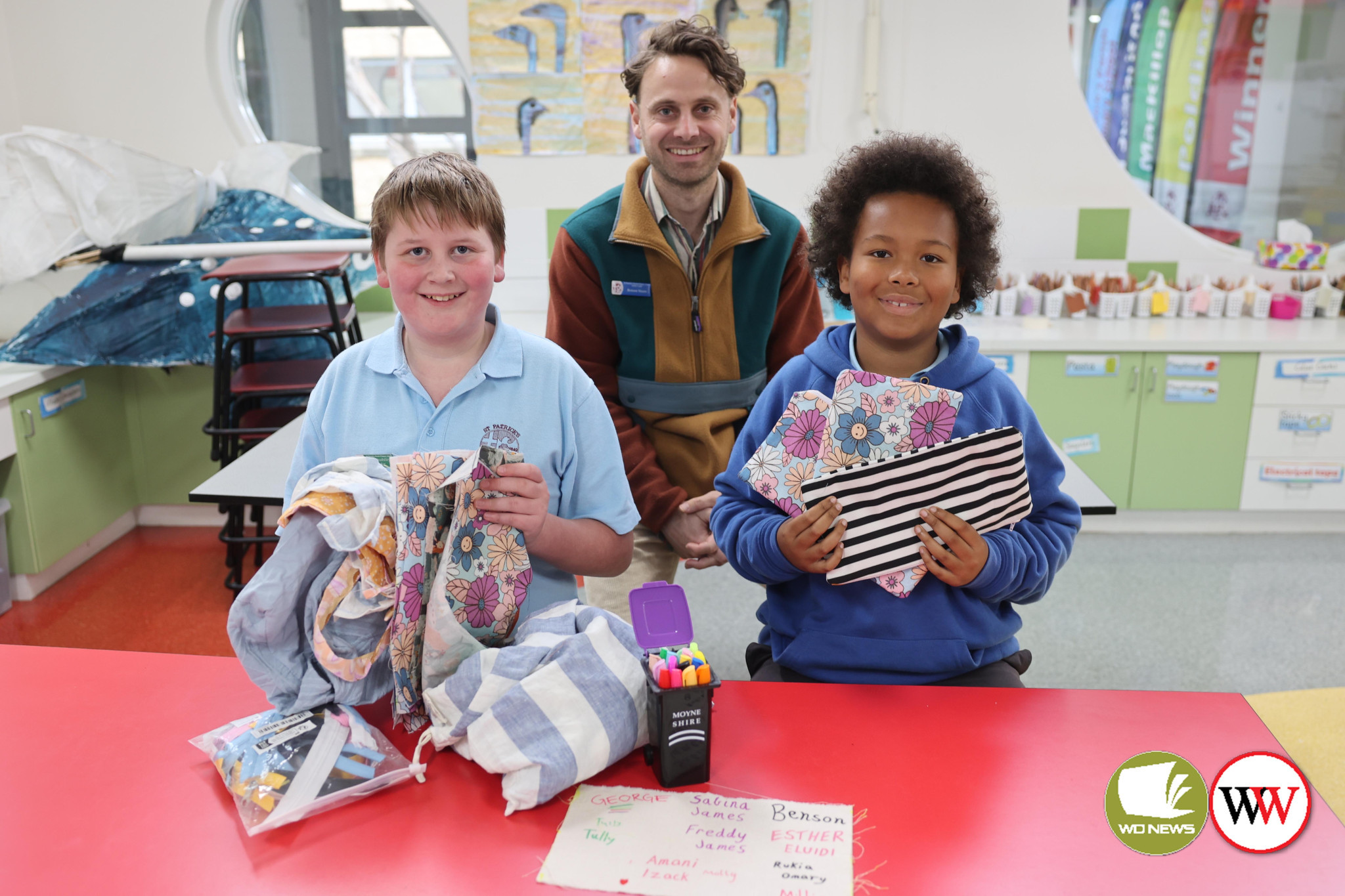 St Patrick’s Primary School teacher Benson Steere with year six students Ben Mirtschin and Kolo Sakate with some of the material pencil cases that will be sent to Tanzania.