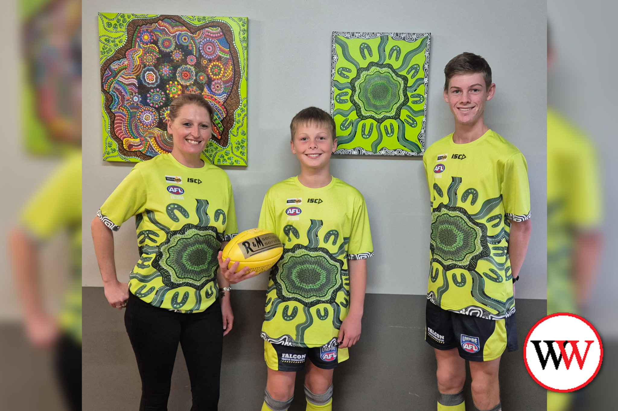 Artist Tinika Clifford (pictured with young umpires Michael and Aaron Lougheed) is looking forward to seeing her design on umpire tops across Hampden League games this weekend.