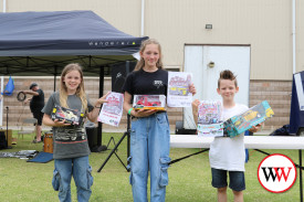 Colouring competition winners Nash Roberts, Kleo Garrett and Lilly Roberts with their prizes.