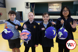 Mason Cox, Gracie Staaks, Hallie Wilson and Louise Xu with their globes.