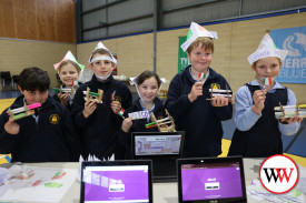 Kai Clifford-Bellville, Morgan Black, Harry Matthews, Savana McGennan, Jove Fish and Kaiya Gleeson wave their miniature flags.