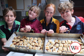 Year four students Basil, Violet, Sadie and Gus were keen to take the sausage rolls to their guests.