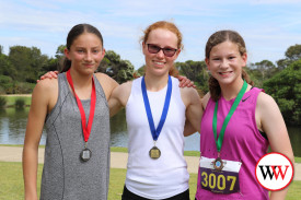 Edith Stretch (centre) took out the women’s 3km lap of the lake, followed by Miranda Jansz (left) in second and Lexie Gleisner third.