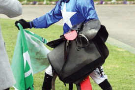 Winning jockey Tom Ryan was all smiles after bringing home The Cunning Fox in race six.