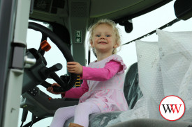 Amelia Daley gets behind the wheel of a tractor.