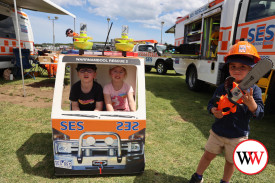 Three year-old Frankie Katrianto (right) was happy to check out the SES play equipment while siblings Jude and Evie Smith of Cobden sat in the miniature rescue vehicle.