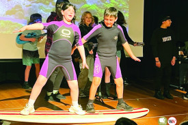 Surfers Katelyn Cousins and Onyx Bowler test their skills to the music of ‘Run to Paradise.’