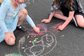 Chalk drawing on the basketball court was a popular activity.