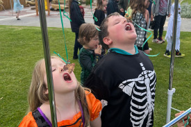 Aaliyah Parkinson and Mason Bradshaw try their luck at eating gingerbread with their hands behind their backs.