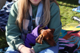 Twelve year-old Zoe Pope of Winslow and her dog ‘Olive’ were happy to sit in the crowd and watch the races.