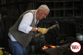 Martin J Sullivan, wheel wright and carriage maker demonstrating his trade.